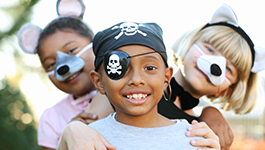 kids smiling in halloween costumes