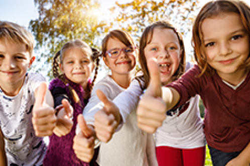 LunchLady_Image11 kids smiling in a row with thumbs up